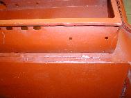 LR - 144002080 - Bulkhead - red-oxide - view of passenger side (rhs) door restraint mounting holes