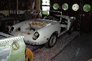 LR - 144002080 - Tub under repair (Fiat Spider in background)
